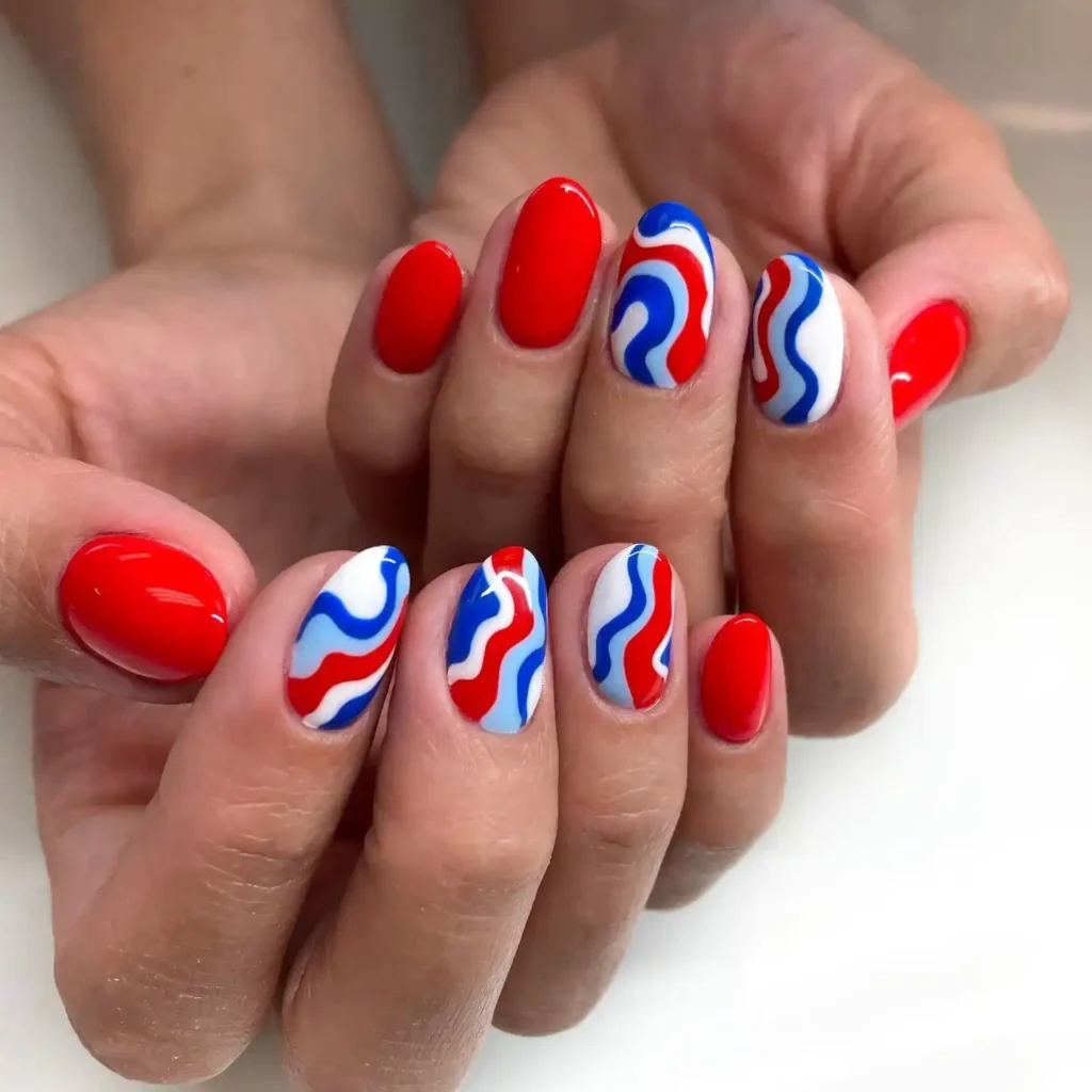 Easy 4th of July nails in red, blue, and white with curved lines for a simple and festive patriotic look