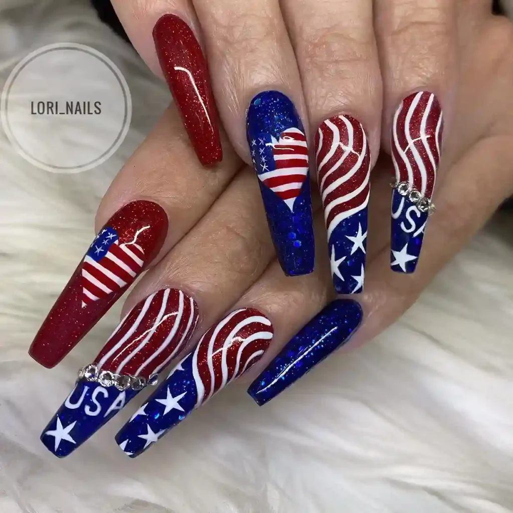 Red white and blue glitter nails with American flag heart design, featuring stars and stripes, ideal for a patriotic 4th of July manicure